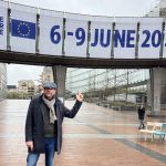 Brendan pointing to a sign above his head for the European elections 2024