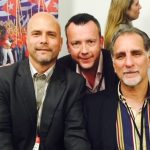 Brendan in the middle of two men looking happy